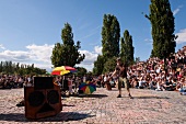 Crowd watching man performing at an event in Prenzlauer Berg, Berlin, Germany