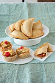 Empanadas and muffins on plate