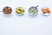 Different fast foods from oven in bowl and plate on white background