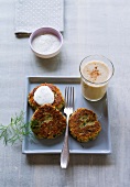 Glass of banana shake and oat biscuits with dill hood on square plate