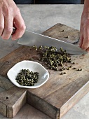Close-up of chopping green pepper on wooden board