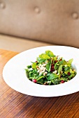 Close-up of salad with pomegranate seeds on plate