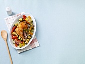 Mediterranean chicken leg with vegetables on plate