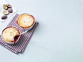 Quark semolina pudding with plums on folded napkin