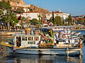 Man on fishing boat at harbor in Cesme, Turkey