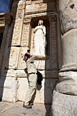 Photographer clicking photos outside library of ancient Ephesus, Aegean, Turkey