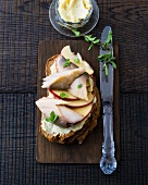 Mackerel fillet with butter and apple slices on bread