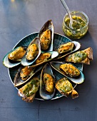 Green shell mussels with green sauce on plate