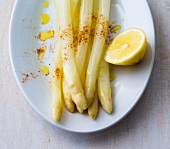 Smoked asparagus with lemon on plate