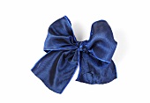 Blue shiny ribbon bow on white background