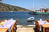 Laid out tables on port in Gumusluk, Bodrum, Aegean Region, Turkey