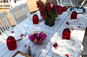 Table laid with flowers and crockery at Mimoza Restaurant, Gumusluk, Aegean Region, Turkey