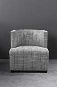 Checked plaid fabric chair against grey wall