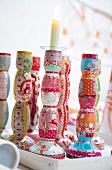 Colourful patterned candle holder with lit candle