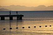 Locals on jetty at sunrise in Kargi bay, Datca, Resadiye Peninsula, Turkey