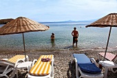 Tourists relaxing on beach of Kargi bay, Datca, Resadiye Peninsula, Turkey