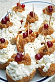 Close-up of skewers of bread with cream cheese and berries