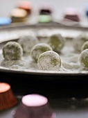 Close-up of green tea truffles with white chocolate