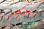 Close-up of various spectacles on display rack in store