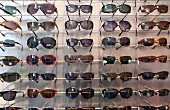 Various sunglasses on shelf at optician