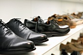 Men's shoes on display at shoe merchandiser