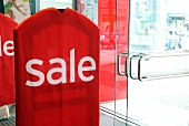 Big red sale signboard at entrance of shop