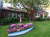 Pink flowers in garden in front of houses, Spiekeroog, Lower Saxony, Germany