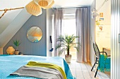 Bedroom with pendant lights, palm tree, window and round mirror