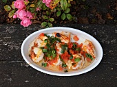 Garlic prawns in serving dish at restaurant, overhead view