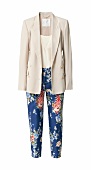 Beige blazer, top and floral patterned blue trousers on white background