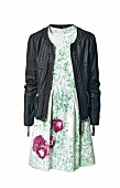 Black leather jacket on green dress with floral print on white background