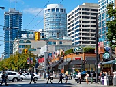 People walking along street against buildings, Vancouver, British Columbia, Canada