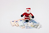 Weihnachtsgeld, Geld, Weihnachtsmann mit Geschenk