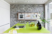 Kitchen with stone wall & green worksurface