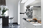 Espresso machine on white counter top in kitchen