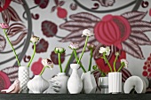 White vases with ranunculus flowers