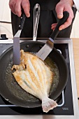 Frying whole plaice in frying pan
