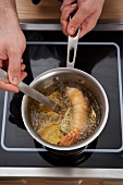 Preparation of lobster in saucepan on a hob
