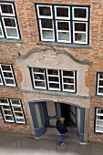 Man entering town library at Lubeck, Schleswig Holstein, Germany