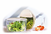 Lettuce in glass bowl with stainless steel lid