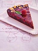 Slice of After Eight tart garnished with raspberry and mint on white serving dish