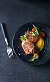 Stuffed veal medallions with apricots, Parma ham and sage