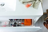 Close-up of vanity unit with open drawer in bathroom