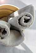 Close-up of gray rolled towels in bathroom