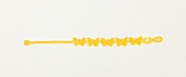 Close-up of yellow friendship bracelet with small butterflies on white background