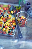 Oven-baked red and yellow cherry tomatoes with olives