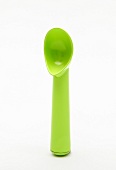 Green ice cream spoon on white background