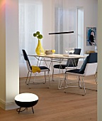 Dining table with yellow vase and pendant light in dining room