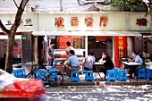People sitting in front of Aisa Snack at French Concession district, Shanghai, China