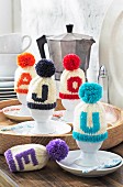 Knitted bobble hat egg warmers with initials